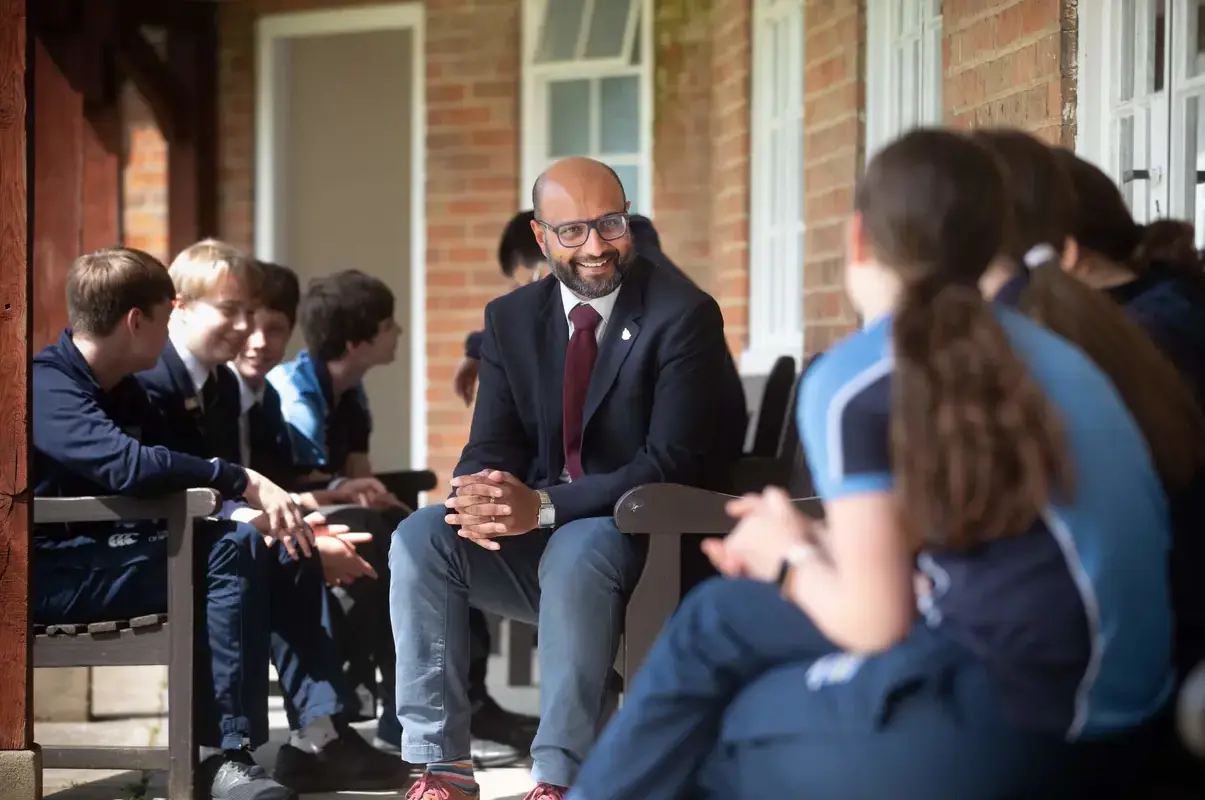 Pocklington School Head of Middle School Inyaat Hashim talking to Middle School pupils outside.